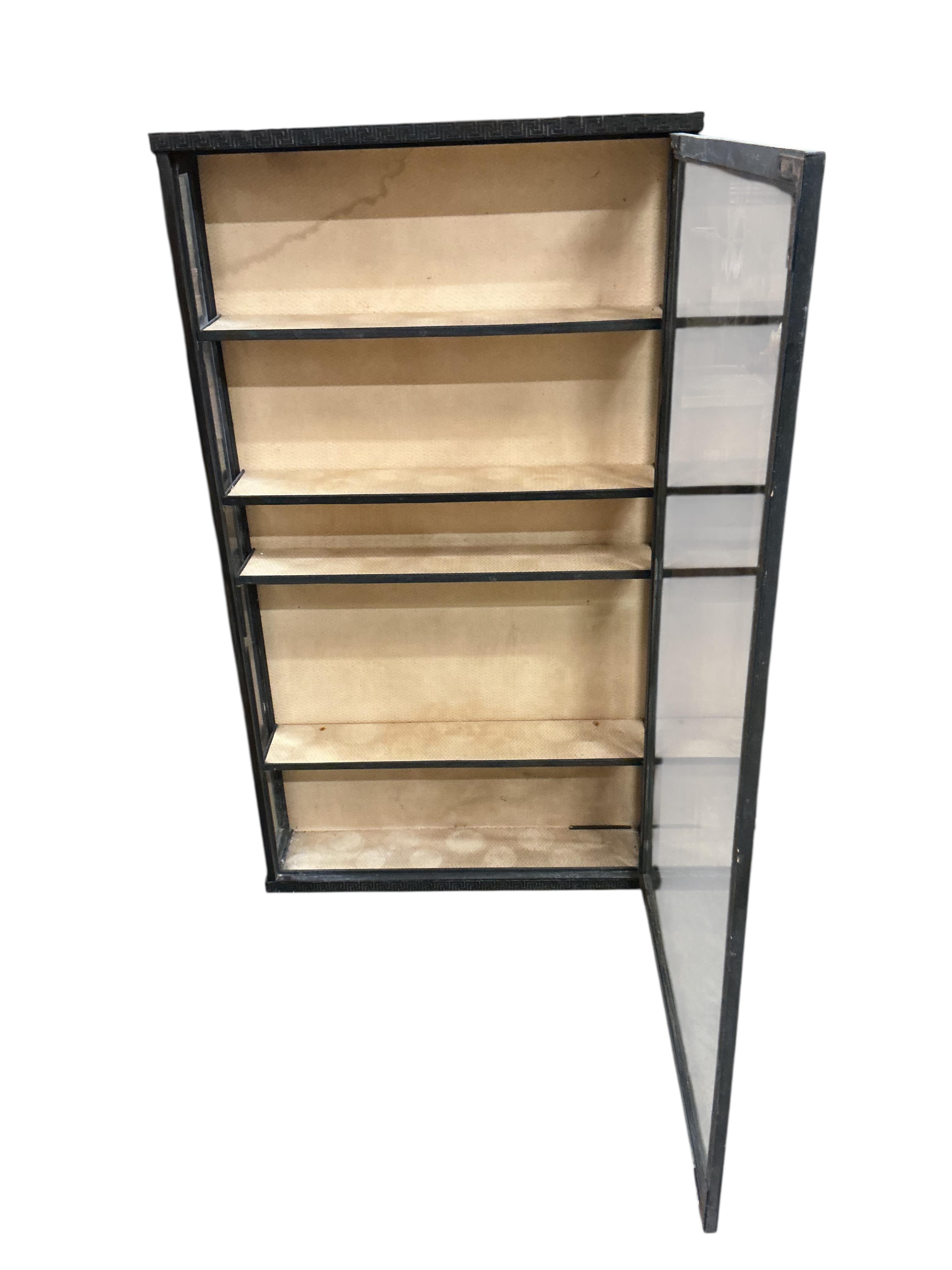 A Regency style ebonised wall cabinet, width 70cm, depth 15cm, height 122cm